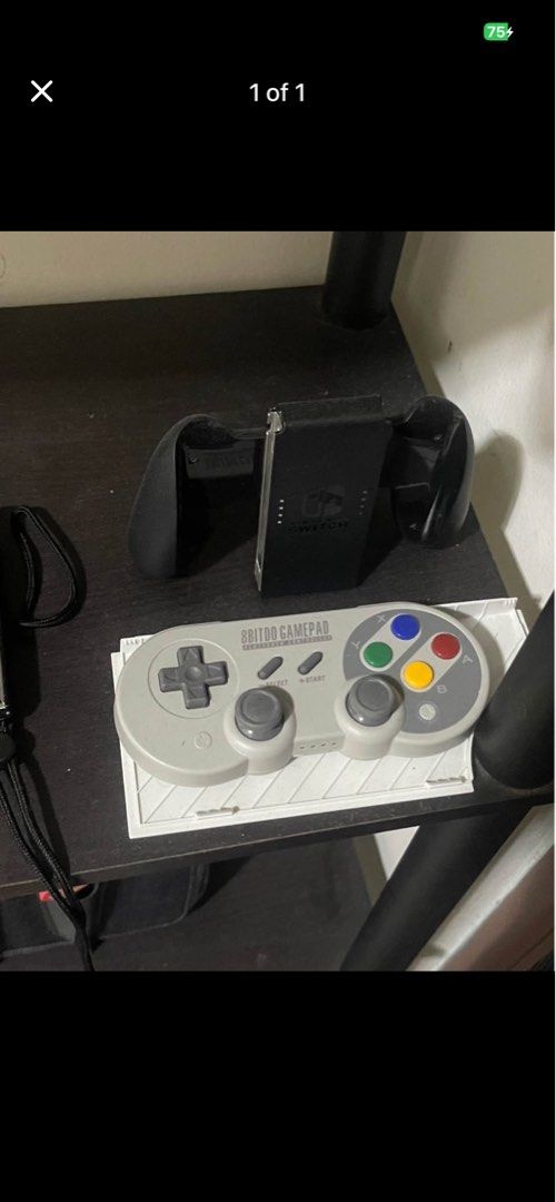 8BitDo SN30 Pro Gamepad and Nintendo Switch Grip (Category: Controllers) located in Manila. Submitted by xyrobadoobee (Listing ID 1440023137, Image 1). Description: RARE WITHOUT BOX Selling an 8BitDo SN30 Pro gamepad with a classic SNES-inspired design. Also includes a black grip accessory for the Nintendo Switch. Perfect for retro gaming enthusiasts and enhancing your Switch gaming experience..