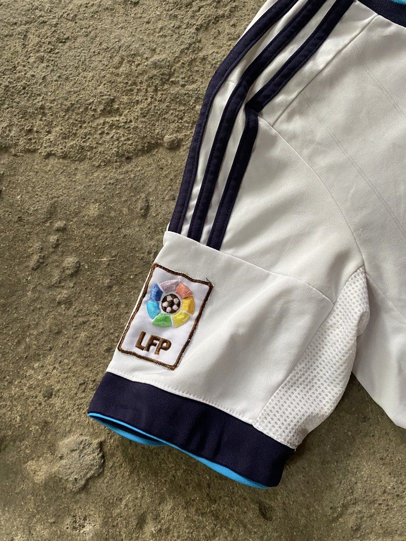 Adidas Real Madrid 2011-2012 Home Jersey Bwin LFP Patch (Category: Activewear) located in Caloocan City. Submitted by remythrift (Listing ID 1440040067, Image 3). Description: - Authentic Adidas Real Madrid home jersey - 2011-2012 season - Features iconic 'bwin' sponsor - Includes LFP patch on sleeve - ClimaCool technology for breathability - Ideal for Real Madrid fans and football collectors.
