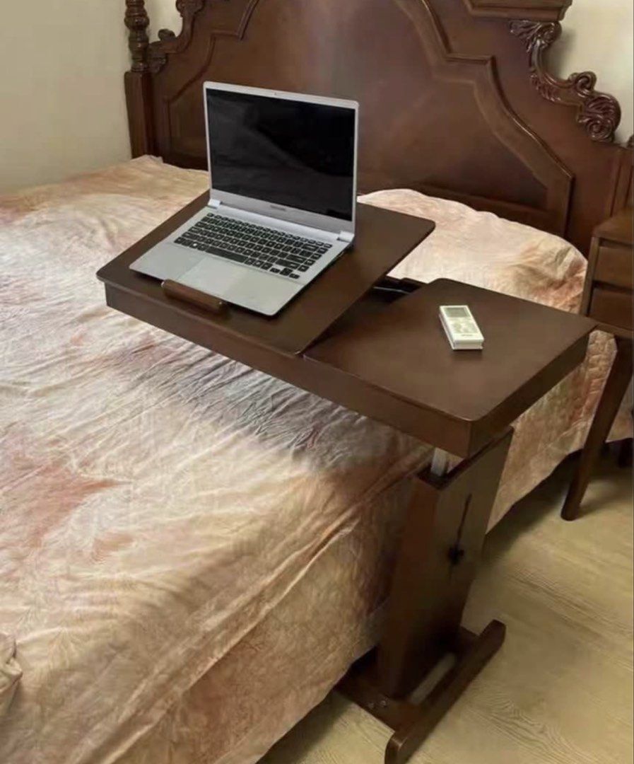 Adjustable Solid Wood Bedside Table (Category: Tables & Sets) located in Singapore. Submitted by alickingdom (Listing ID 1439996769, Image 3). Description: - Versatile bedside table for use over bed or sofa - Adjustable height for your comfort - Spacious surface ideal for laptops, books, or snacks - Sleek wooden design to match any decor - 80cm x 40cm x adjustable.