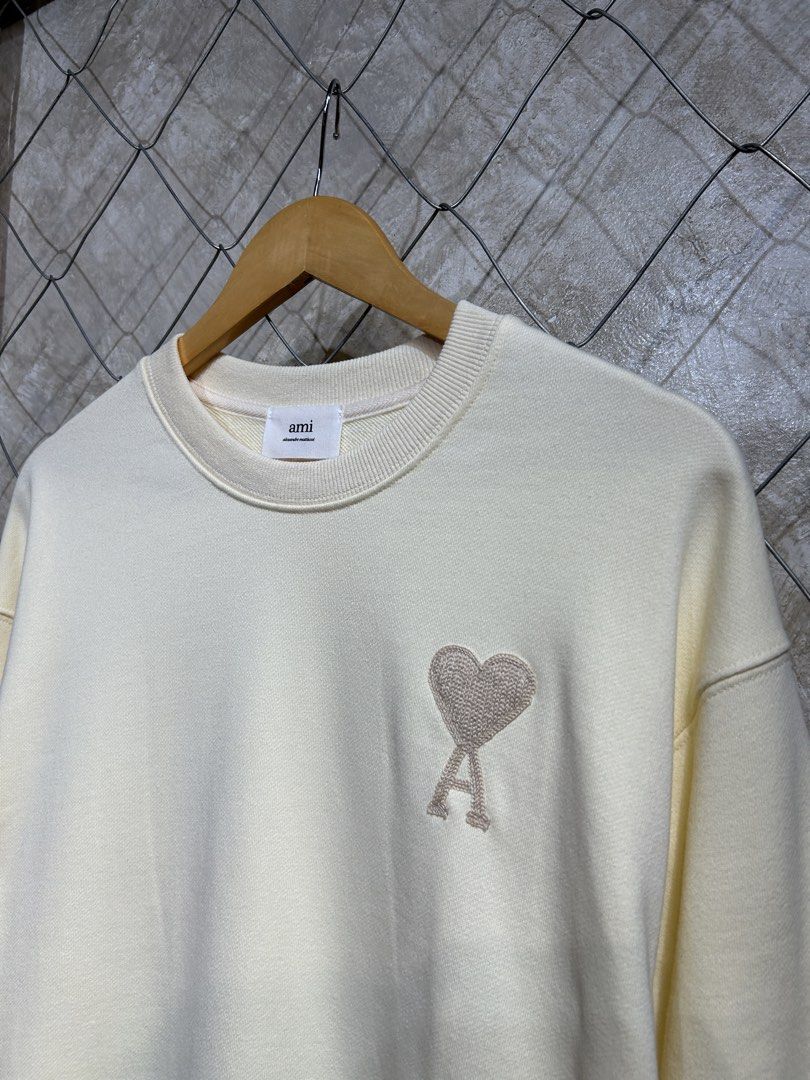 AMI Paris Crewneck Sweatshirt - Cream (Category: Coats, Jackets and Outerwear) located in Manila. Submitted by ardobe.mnl (Listing ID 1440169871, Image 3). Description: Ami Paris Small Logo Cream Crewneck. Size: Large Dimes: 22x27 Condition: Good asnew Flaw: None! Dm for inquiries! 📥.