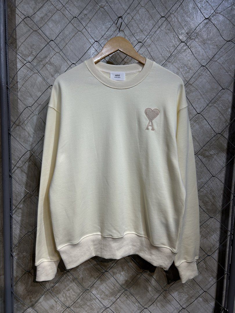AMI Paris Crewneck Sweatshirt - Cream (Category: Coats, Jackets and Outerwear) located in Manila. Submitted by ardobe.mnl (Listing ID 1440169871, Image 1). Description: Ami Paris Small Logo Cream Crewneck. Size: Large Dimes: 22x27 Condition: Good asnew Flaw: None! Dm for inquiries! 📥.