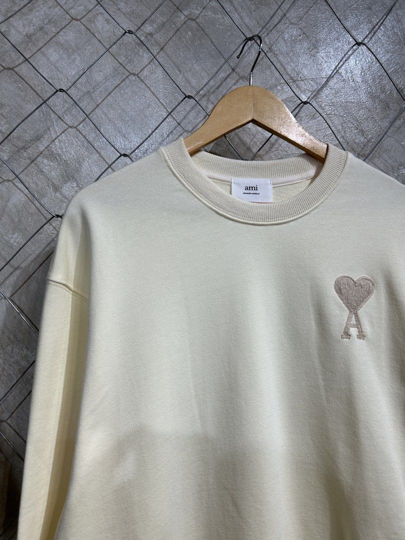 AMI Paris Crewneck Sweatshirt - Cream (Category: Coats, Jackets and Outerwear) located in Manila. Submitted by ardobe.mnl (Listing ID 1440169871, Image 2). Description: Ami Paris Small Logo Cream Crewneck. Size: Large Dimes: 22x27 Condition: Good asnew Flaw: None! Dm for inquiries! 📥.
