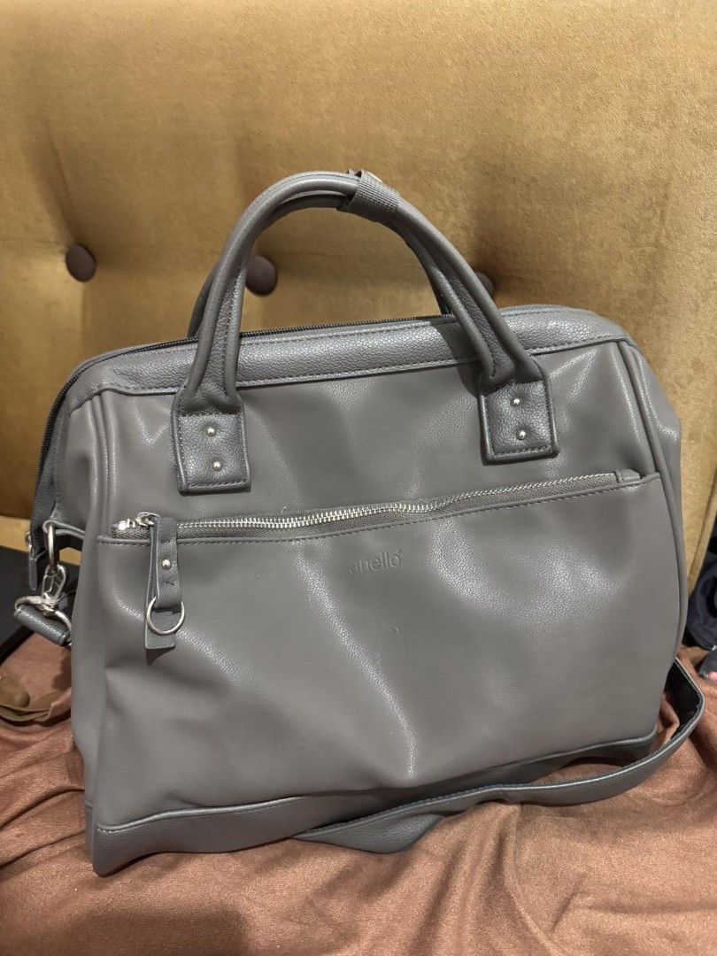 Anello Grey Leather Satchel Bag with Shoulder Strap (Category: Shoulder Bags) located in Manila. Submitted by akirese (Listing ID 1440166696, Image 1). Description: - Stylish and functional Anello satchel bag in versatile grey. - Spacious main compartment for all your essentials. - Convenient front zippered pocket for quick access. - Comfortable top handles for easy carrying. - Adjustable and detachable shoulder strap for versatile wear. - Made w