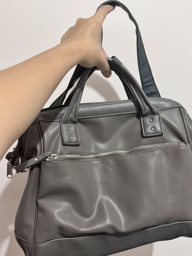 Anello Grey Leather Satchel Bag with Shoulder Strap (Category: Shoulder Bags) located in Manila. Submitted by akirese (Listing ID 1440166696, Image 2). Description: - Stylish and functional Anello satchel bag in versatile grey. - Spacious main compartment for all your essentials. - Convenient front zippered pocket for quick access. - Comfortable top handles for easy carrying. - Adjustable and detachable shoulder strap for versatile wear. - Made w