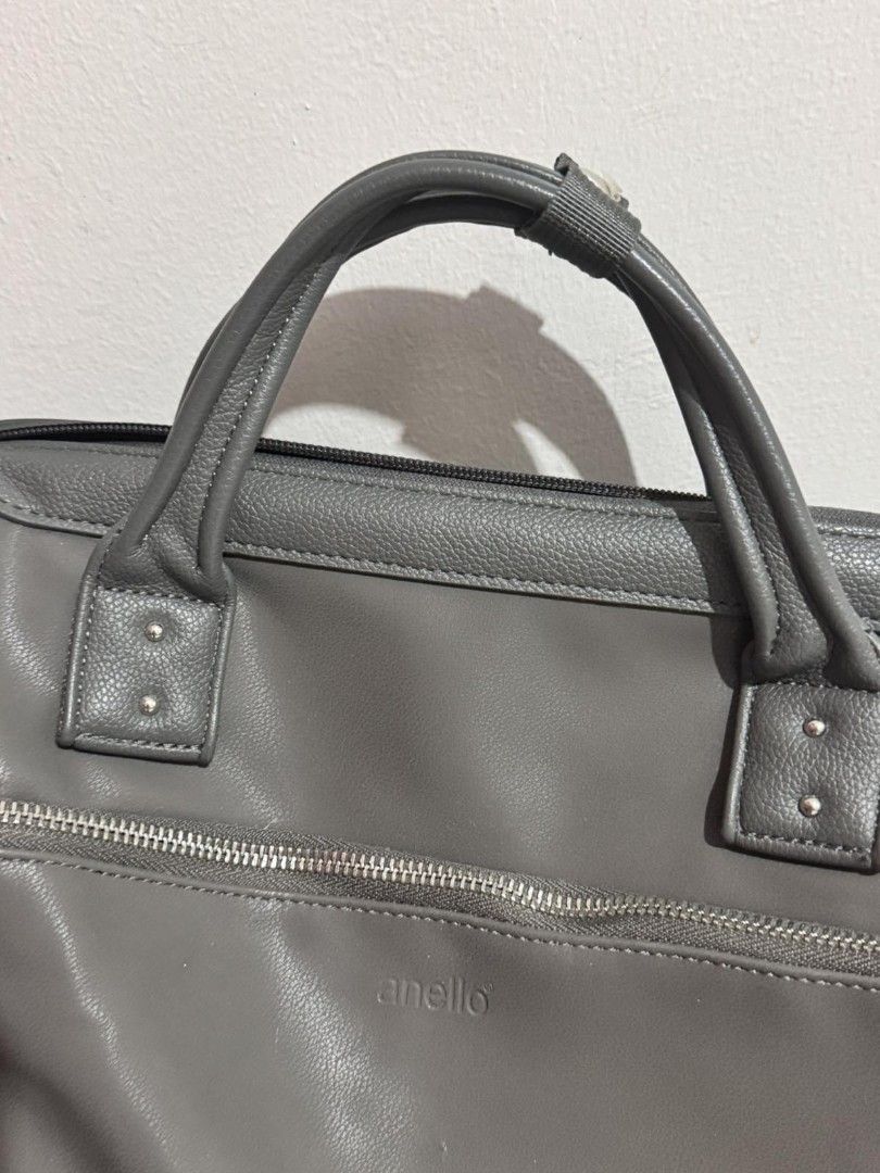 Anello Grey Leather Satchel Bag with Shoulder Strap (Category: Shoulder Bags) located in Manila. Submitted by akirese (Listing ID 1440166696, Image 3). Description: - Stylish and functional Anello satchel bag in versatile grey. - Spacious main compartment for all your essentials. - Convenient front zippered pocket for quick access. - Comfortable top handles for easy carrying. - Adjustable and detachable shoulder strap for versatile wear. - Made w