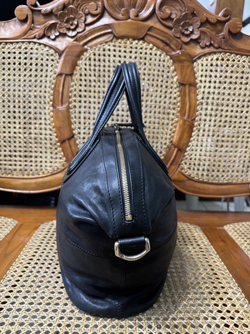 [AUTHENTIC] Givenchy Nightingale Bag (Category: Luxury Bags & Wallets) located in Santa Rosa. Submitted by rjaarmblo (Listing ID 1440153298, Image 2). Description: - Black Givenchy bag - Zipper closure - Leather interior - Givenchy label - Includes tag with code: "MA-10162" - Size tag included - Very good condition - Includes base shaper and pillow stuffer - Flaws: Creases sa handles but no peeling.