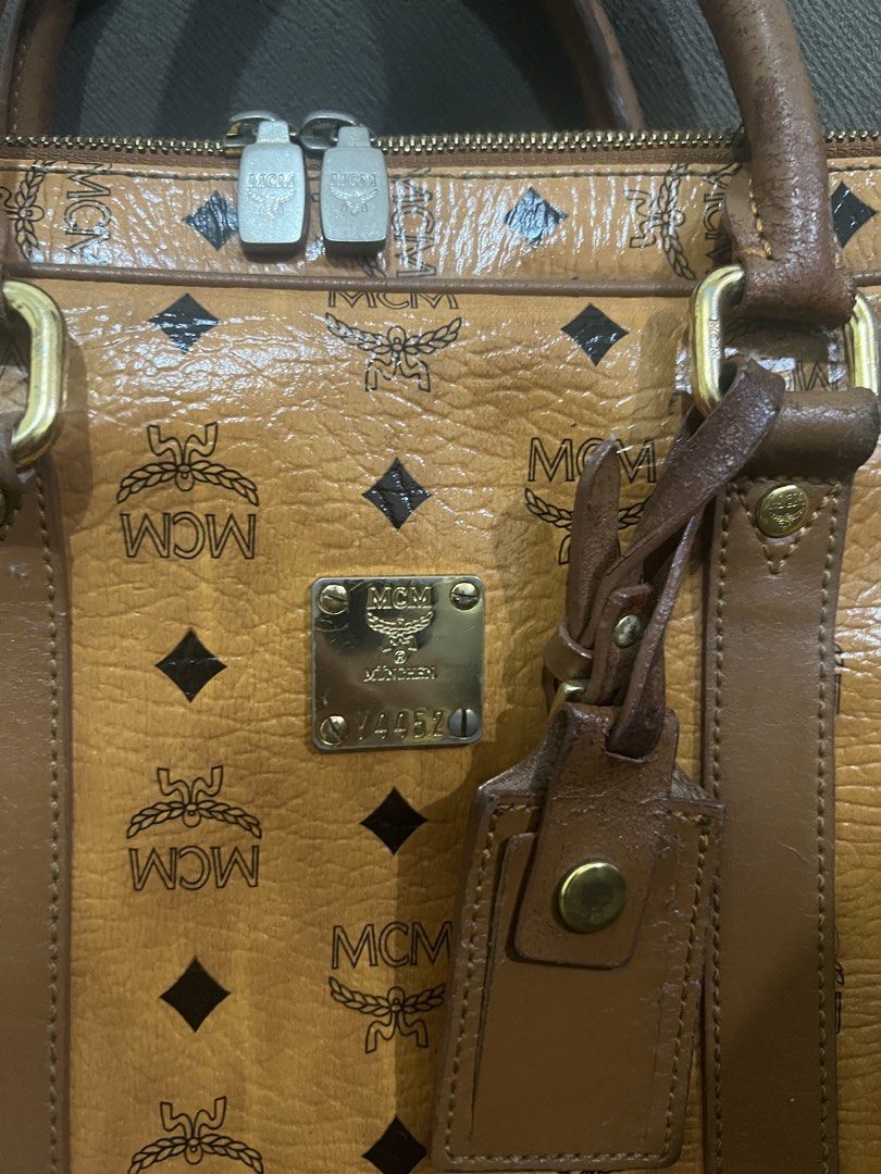 Authentic MCM Cognac Laptop/Document Bag (Category: Luxury Bags & Wallets) located in Manila. Submitted by sanyatagle08878 (Listing ID 1440089684, Image 2). Description: - Authentic MCM Cognac Laptop/Document Bag - Can fit 13-inch laptop - Turnable screws - Gold MCM logo plate on front Issues: Please check the photos posted. Some issues are labas piping, bag handle scratches and in some part of the bags. Location: La Loma, QC RFS: decluttering so