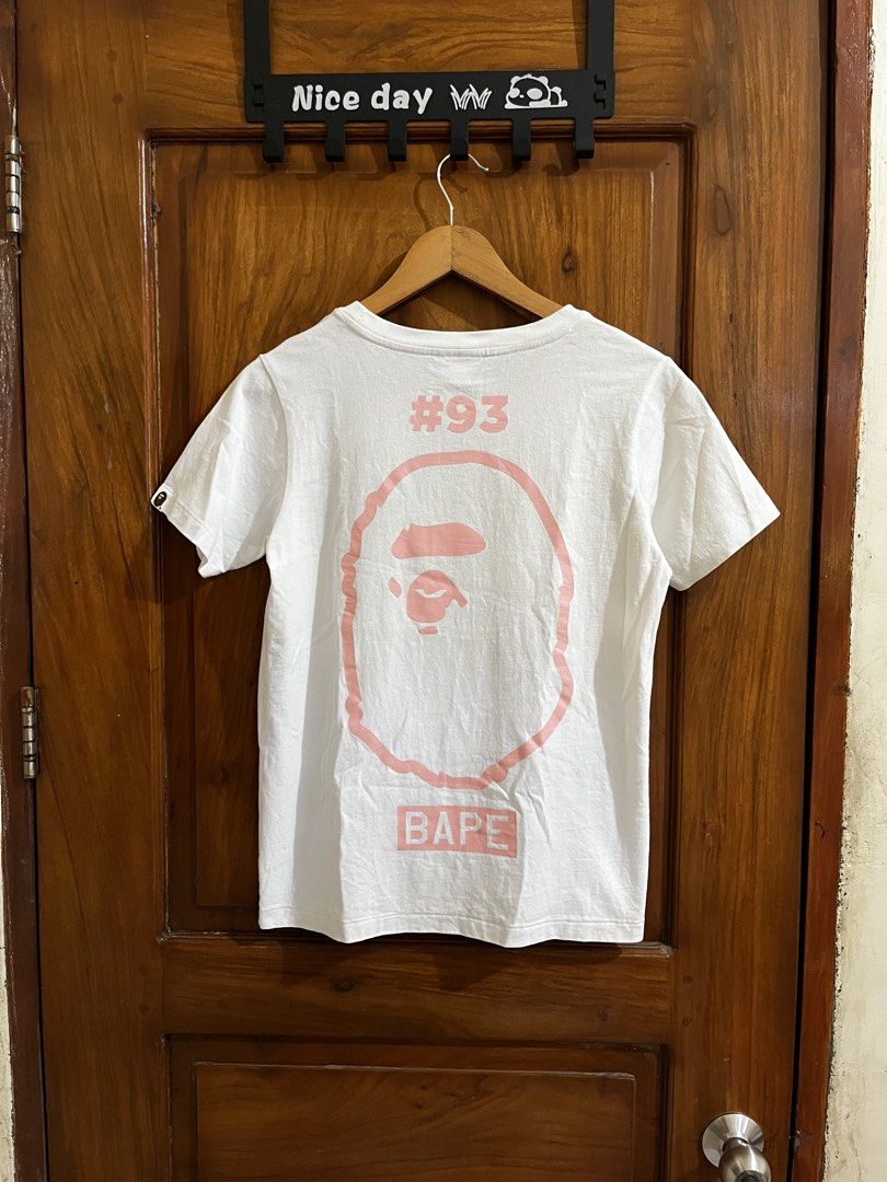 BAPE A Bathing Ape Ladies "World Gone MAD!!" Tee XS (Category: Shirts) located in Bula. Submitted by thrift.wyn (Listing ID 1440031668, Image 2). Description: - Authentic BAPE A Bathing Ape Ladies T-shirt - Color: White - Size: XS - Front Graphic: 'World Gone MAD!!' - Back Graphic: Large ape head with '#93' and 'BAPE' -Yellow stain to be safe washable .