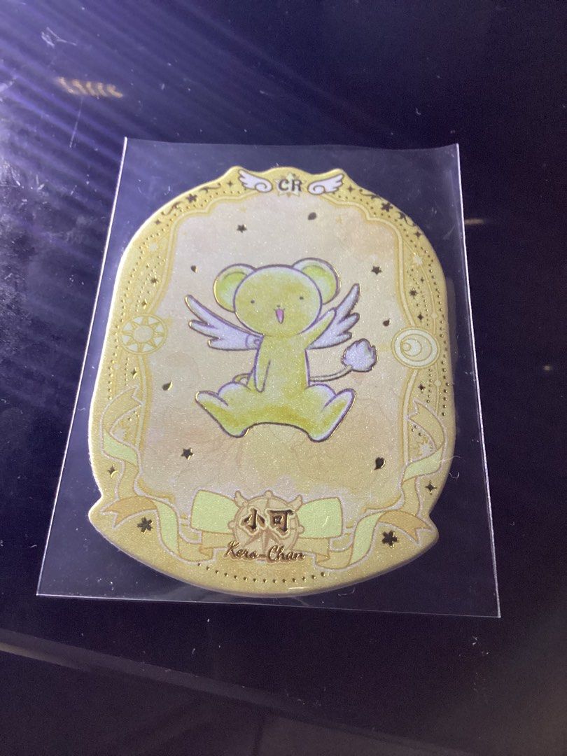 Card Captor Sakura Kero-chan Card (Category: Raw Singles) located in Caloocan City. Submitted by lostrtrp (Listing ID 1440159302, Image 1). Description: - Cute Kero-chan sticker from Card Captor Sakura - Features a yellow and gold design on the front - Back includes the anime title in Japanese and English - Ideal for collectors and fans of the series - Small and portable size.
