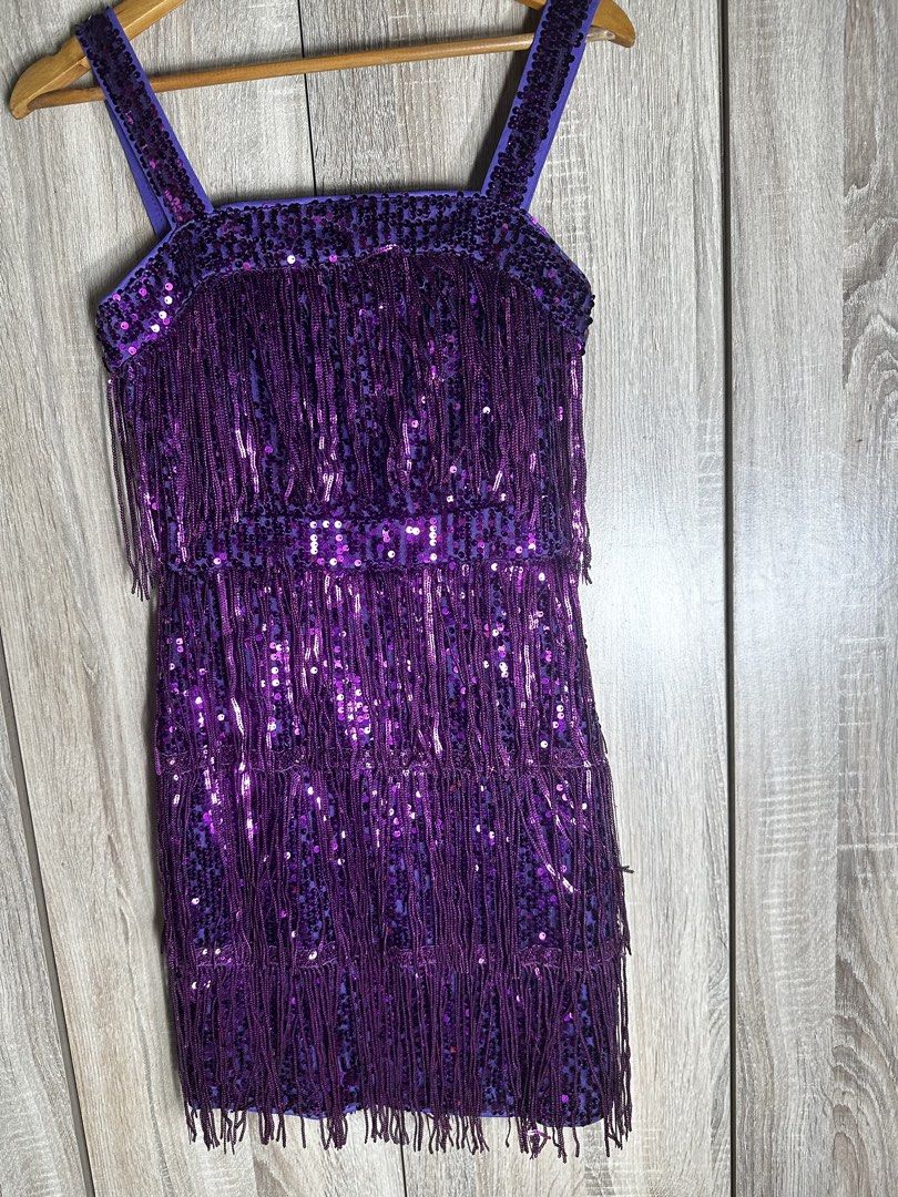 CHOSMO Purple Sequin Fringe Flapper Dress (Category: Dresses) located in Baguio. Submitted by ramosroch78721 (Listing ID 1440021508, Image 1). Description: - Dazzling purple flapper dress by CHOSMO - Features a sequin base - Shimmering fringe layers - Beaded straps for extra sparkle - Ideal for parties, Halloween, or any festive occasion - Vibrant and eye-catching design.