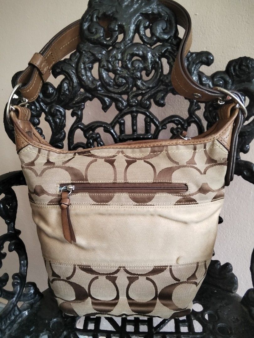 Coach Monogram Canvas Leather Hobo Shoulder Bag (Category: Luxury Bags & Wallets) located in Bugasong. Submitted by sofiewaffle (Listing ID 1440086420, Image 2). Description: - Authentic Coach hobo bag - Signature monogram canvas with genuine leather trim - Zippered main compartment - Exterior zippered pocket for easy access - Adjustable leather strap for comfortable wear - Stylish and practical for everyday use -well used but good used p po.