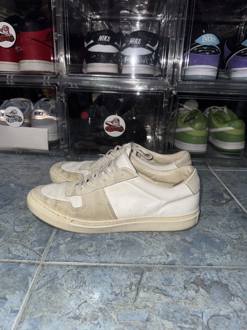Common Projects BBall Low Leather Sneaker (Category: Sneakers) located in Pasay City. Submitted by vinsanity41546 (Listing ID 1440165660, Image 2). Description: needs cleaning - Classic low-top sneakers - Brand: Common Projects - Made in Italy - Material: White leather and suede panels - Signature gold-tone serial number embossed on heel - Minimalist design - Perfect for everyday wear.
