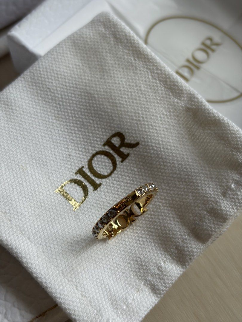 Dio(r)evolution Ring (Category: Rings) located in Singapore. Submitted by geraldjerald (Listing ID 1440140680, Image 5). Description: - Authentic Dior ring - Gold-tone finish - Features iconic 'DIOR' logo - Embellished with sparkling crystals - Includes original Dior box and paper bag .