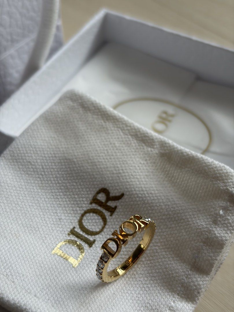 Dio(r)evolution Ring (Category: Rings) located in Singapore. Submitted by geraldjerald (Listing ID 1440140680, Image 4). Description: - Authentic Dior ring - Gold-tone finish - Features iconic 'DIOR' logo - Embellished with sparkling crystals - Includes original Dior box and paper bag .