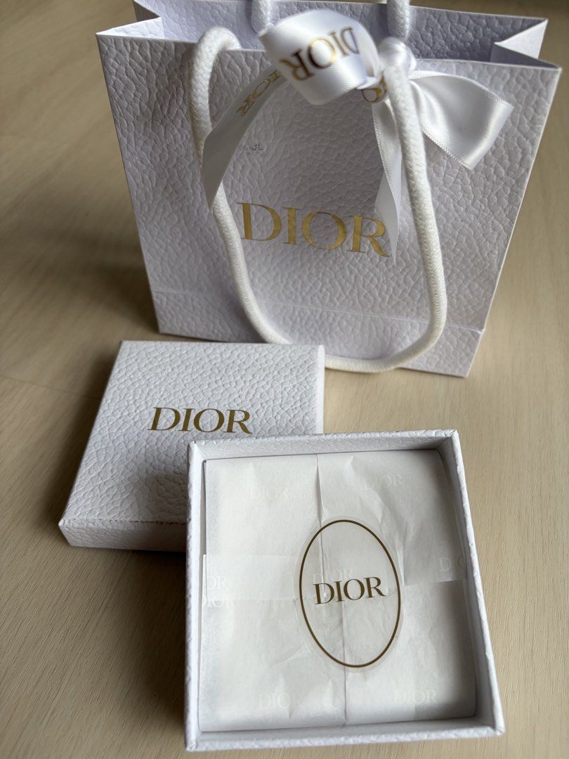 Dio(r)evolution Ring (Category: Rings) located in Singapore. Submitted by geraldjerald (Listing ID 1440140680, Image 6). Description: - Authentic Dior ring - Gold-tone finish - Features iconic 'DIOR' logo - Embellished with sparkling crystals - Includes original Dior box and paper bag .