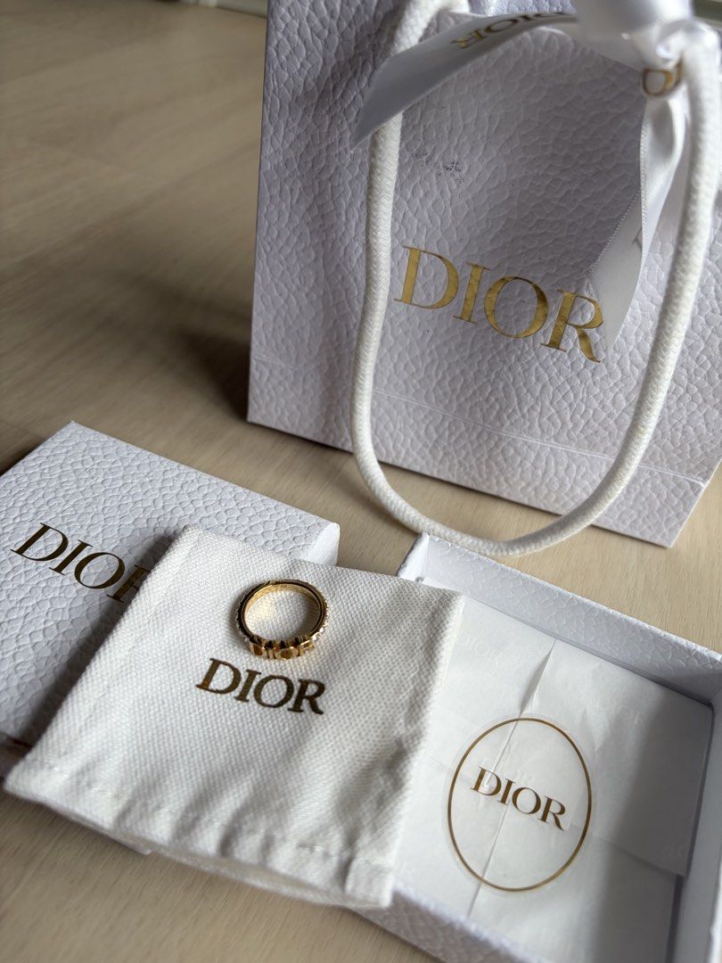 Dio(r)evolution Ring (Category: Rings) located in Singapore. Submitted by geraldjerald (Listing ID 1440140680, Image 7). Description: - Authentic Dior ring - Gold-tone finish - Features iconic 'DIOR' logo - Embellished with sparkling crystals - Includes original Dior box and paper bag .