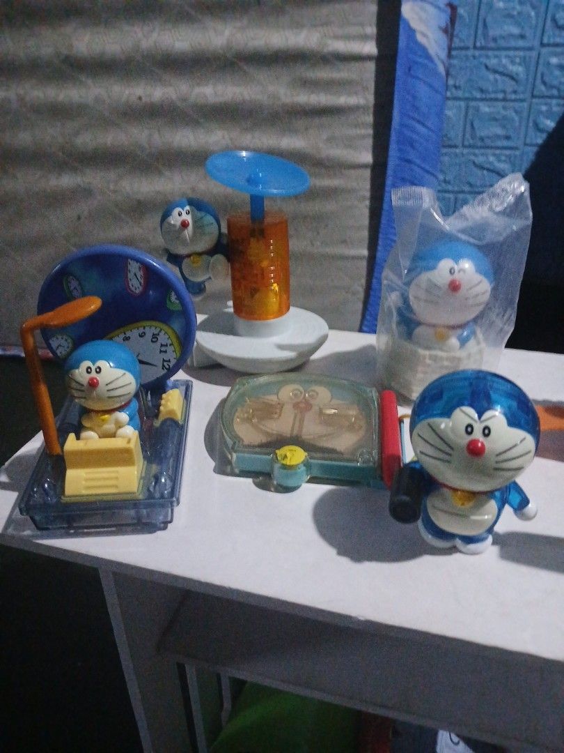 Doraemon mcdonalds Toys Collections (Category: Character Goods) located in Manila. Submitted by diczenestr94951 (Listing ID 1440098323, Image 3). Description: - Collection of Doraemon toys in various poses and with accessories. - Includes: Doraemon with wings, Doraemon in a clear case, Doraemon with a suction cup, and Doraemon with a clock. - Some items are still in their original packaging. - Perfect for Doraemon enthusiasts and collectors..
