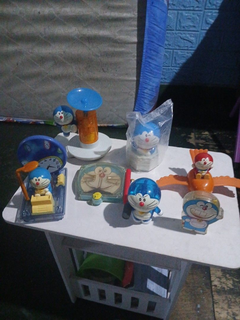 Doraemon mcdonalds Toys Collections (Category: Character Goods) located in Manila. Submitted by diczenestr94951 (Listing ID 1440098323, Image 1). Description: - Collection of Doraemon toys in various poses and with accessories. - Includes: Doraemon with wings, Doraemon in a clear case, Doraemon with a suction cup, and Doraemon with a clock. - Some items are still in their original packaging. - Perfect for Doraemon enthusiasts and collectors..