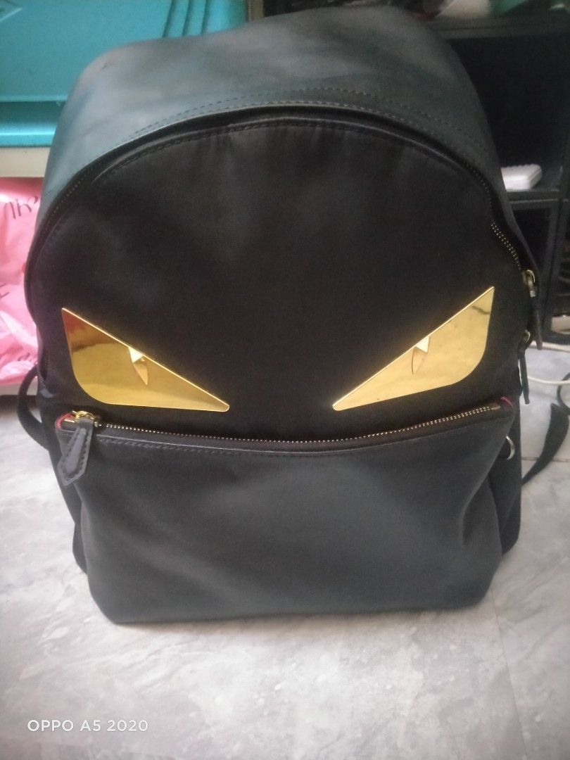 Fendi Monster Backpack Black Gold Eyes (Category: Backpacks) located in Manila. Submitted by chanlice0834788 (Listing ID 1440018556, Image 1). Description: - Stylish black Fendi backpack - Iconic gold monster eyes - Spacious main compartment with red interior lining - Front zippered pocket - RFID label for authenticity - Made in Italy.