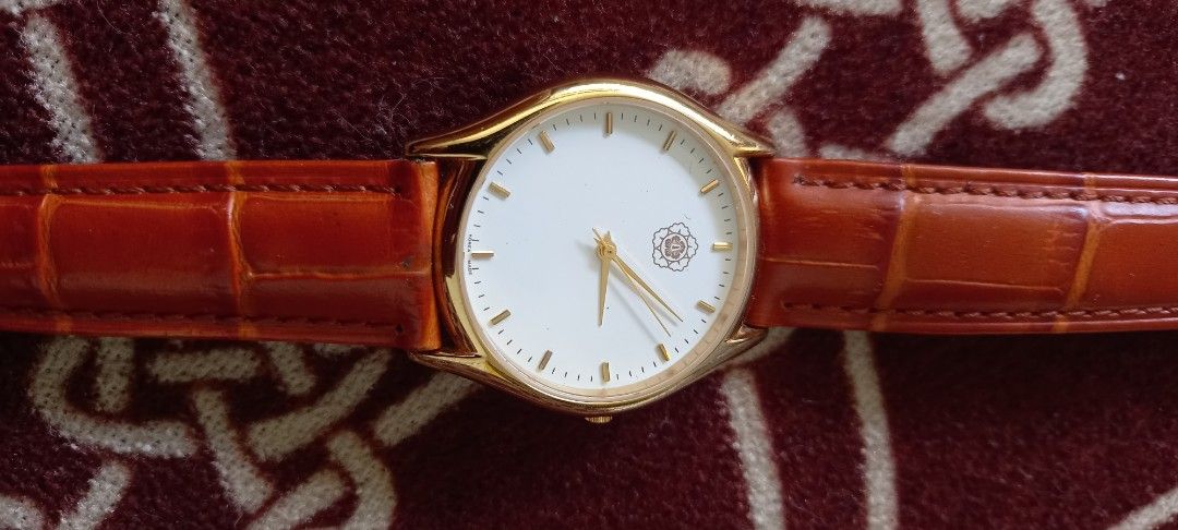 Gold Tone Watch with Brown Leather Strap (Category: Women's Watches) located in Manila. Submitted by fmpc7878 (Listing ID 1440059781, Image 1). Description: - Elegant gold-tone watch - Clean white dial with subtle rose leather strap - Silver buckle - Classic design, suitable for everyday or special occasions - Inscribed text on the back of the watch case GENUINE LEATHER BRACELET NEW BATTERY used, COMMEMORATIVE WATCH.