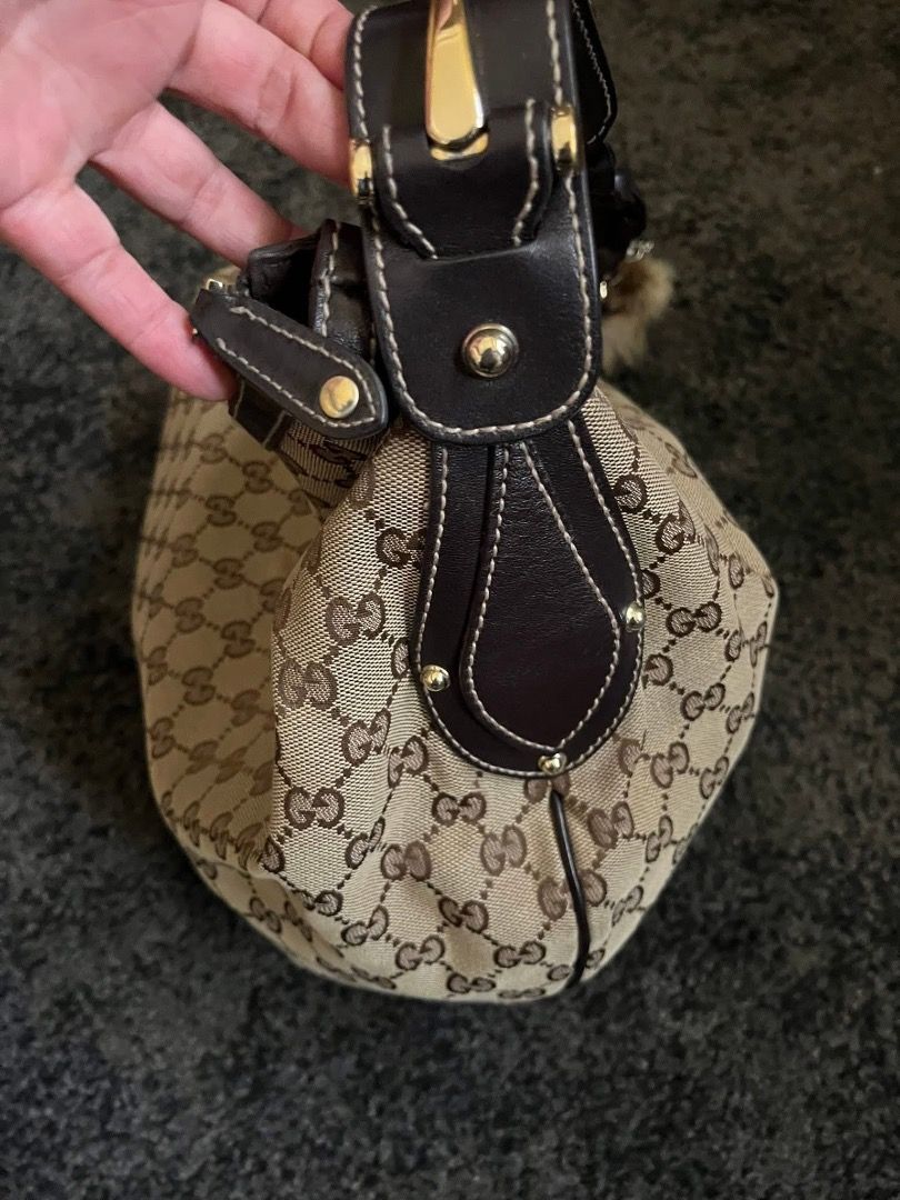 Gucci Monogram Canvas Hobo Bag with Fur Charm (Category: Luxury Bags & Wallets) located in Manila. Submitted by evie-mcalam45 (Listing ID 1440147738, Image 1). Description: - Authentic Gucci Hobo Bag - Iconic GG Monogram Canvas - Dark Brown Leather Trim & Strap - Gold-Tone Hardware - Detachable Fur Charm Included - Secure Zippered Closure.