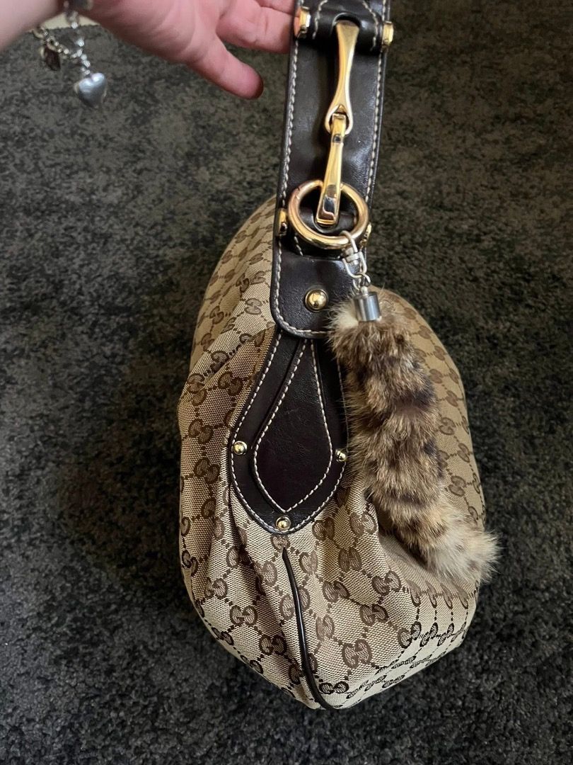 Gucci Monogram Canvas Hobo Bag with Fur Charm (Category: Luxury Bags & Wallets) located in Manila. Submitted by evie-mcalam45 (Listing ID 1440147738, Image 2). Description: - Authentic Gucci Hobo Bag - Iconic GG Monogram Canvas - Dark Brown Leather Trim & Strap - Gold-Tone Hardware - Detachable Fur Charm Included - Secure Zippered Closure.