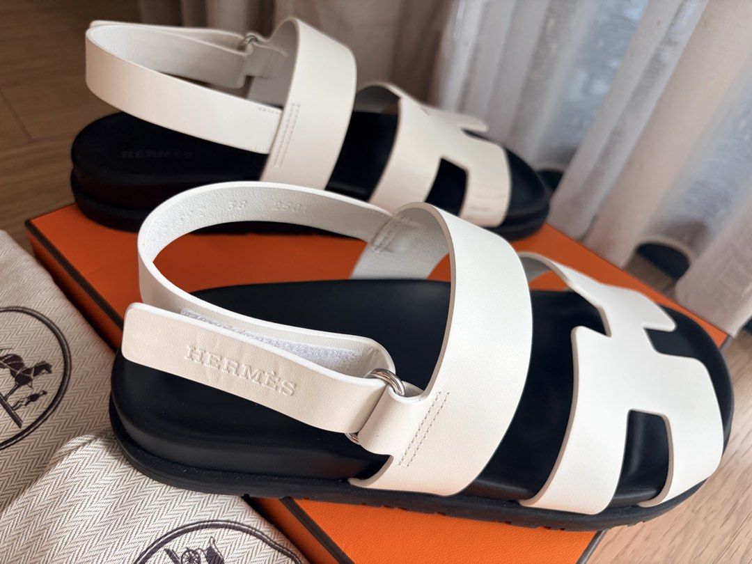 Hermes Genius Sandals Size 38 (Category: Sneakers & Footwear) located in Singapore. Submitted by stuffweloved38 (Listing ID 1440044551, Image 3). Description: - Brand: Hermes - Model: Genius Sandals - Size: EUR 38 - Color: White with black sole - Features: Iconic H design, adjustable strap Some scuffs at the side of the sandals Soles are still very new Comes with Original Hermes dust bags and box. Soft copy of receipt available .