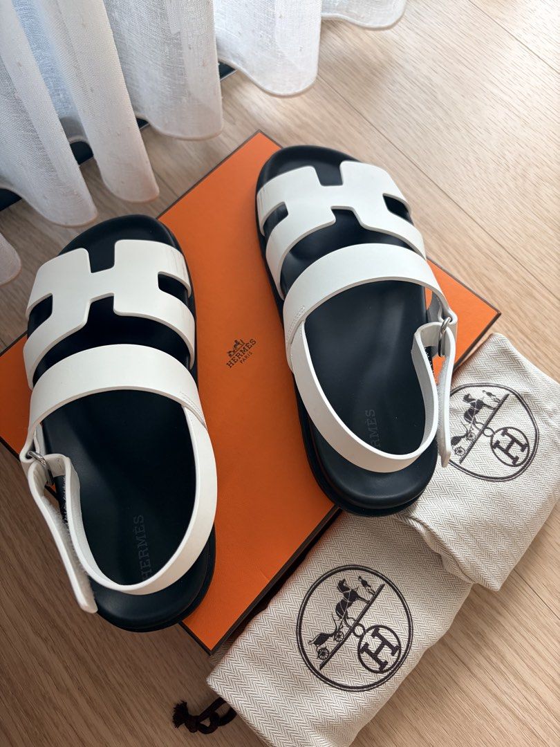 Hermes Genius Sandals Size 38 (Category: Sneakers & Footwear) located in Singapore. Submitted by stuffweloved38 (Listing ID 1440044551, Image 1). Description: - Brand: Hermes - Model: Genius Sandals - Size: EUR 38 - Color: White with black sole - Features: Iconic H design, adjustable strap Some scuffs at the side of the sandals Soles are still very new Comes with Original Hermes dust bags and box. Soft copy of receipt available .
