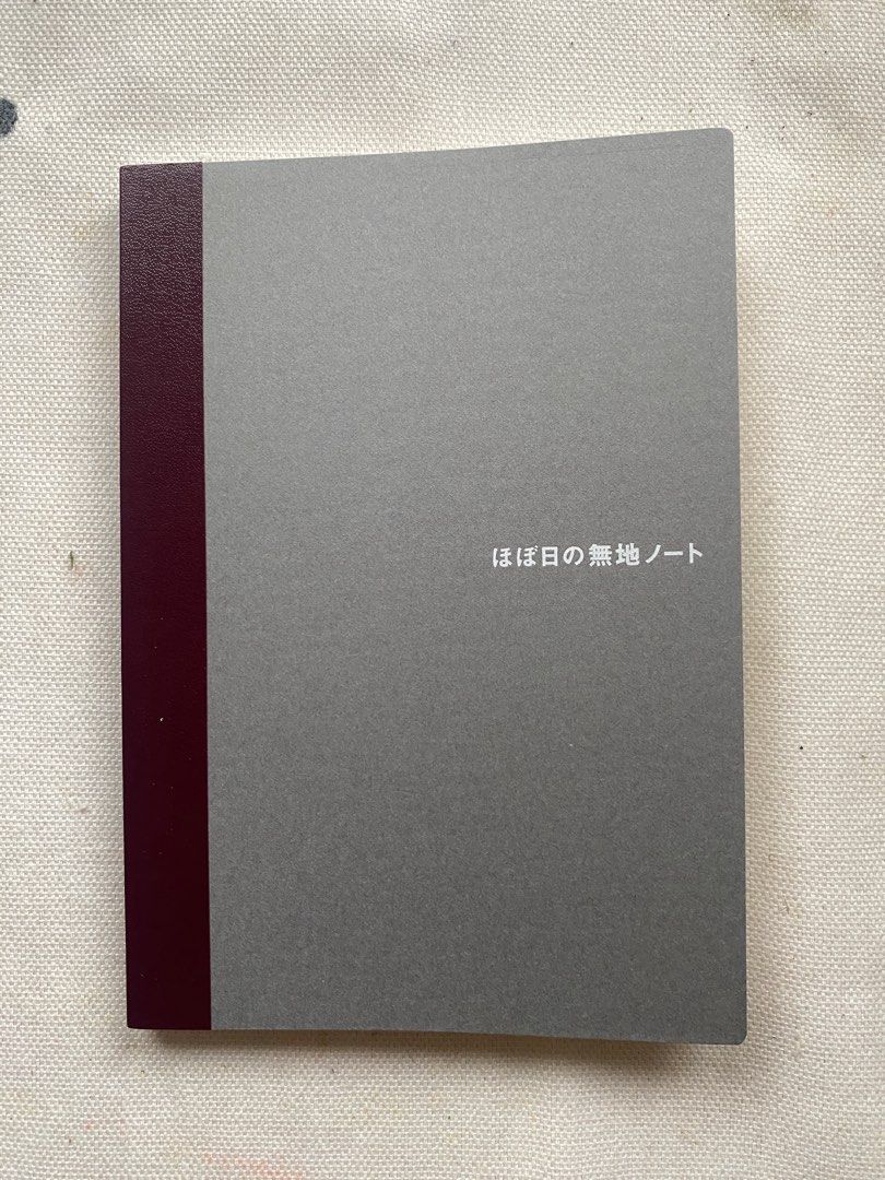 Hobonichi Plain Notebook A6 Size (Category: Stationery & School Supplies) located in Davao. Submitted by iam_artisan (Listing ID 1440075640, Image 1). Description: - Hobonichi A6 Plain Notebook - Elegant grey cover with dark red spine - Blank pages perfect for writing, drawing, or journaling - Ideal for everyday notes and creative projects - Tomoe River Paper - Lays Flat - Fountain pen and other writing tool friendly - 240 pages.