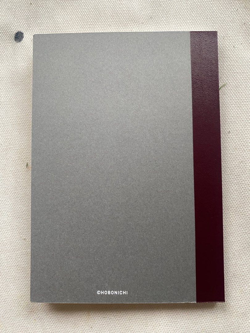 Hobonichi Plain Notebook A6 Size (Category: Stationery & School Supplies) located in Davao. Submitted by iam_artisan (Listing ID 1440075640, Image 2). Description: - Hobonichi A6 Plain Notebook - Elegant grey cover with dark red spine - Blank pages perfect for writing, drawing, or journaling - Ideal for everyday notes and creative projects - Tomoe River Paper - Lays Flat - Fountain pen and other writing tool friendly - 240 pages.