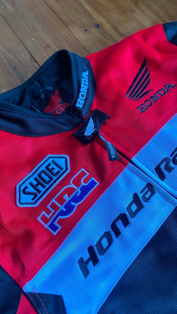 Honda Racing HRC Motorcycle Jacket (Category: Coats, Jackets and Outerwear) located in Gapan. Submitted by alfiesimon43550 (Listing ID 1440109066, Image 3). Description: - Authentic Honda Racing Jacket - Striking Red, Black, and White Design - Features prominent HRC and Shoei Logos - Made with breathable Mesh material for comfort - Full front zipper closure - Honda branding details on sleeves and collar - Ideal for motorcycle riding - Manufacture