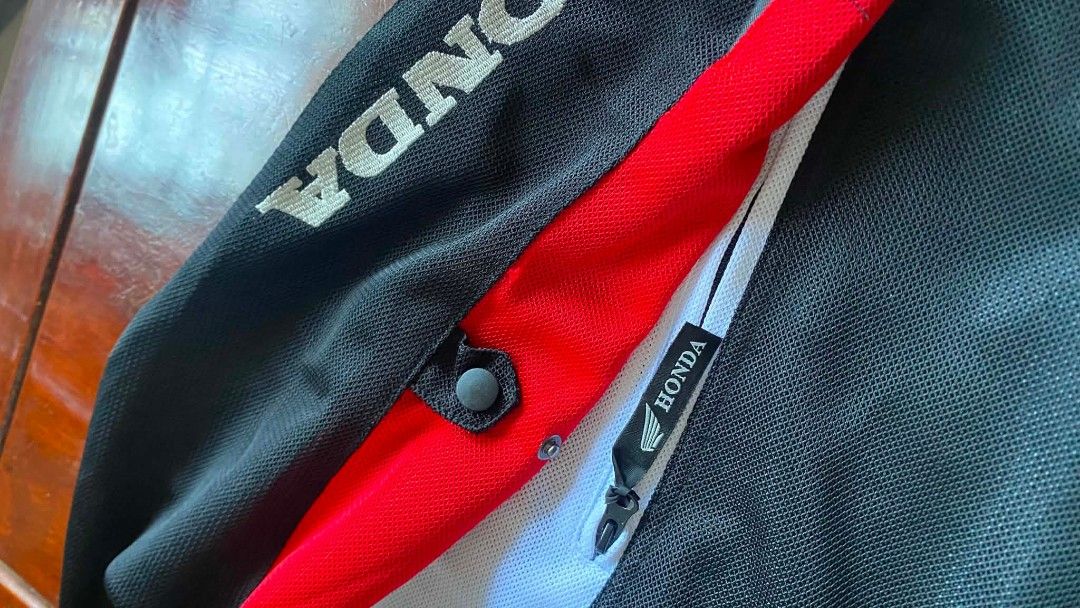 Honda Racing HRC Motorcycle Jacket (Category: Coats, Jackets and Outerwear) located in Gapan. Submitted by alfiesimon43550 (Listing ID 1440109066, Image 2). Description: - Authentic Honda Racing Jacket - Striking Red, Black, and White Design - Features prominent HRC and Shoei Logos - Made with breathable Mesh material for comfort - Full front zipper closure - Honda branding details on sleeves and collar - Ideal for motorcycle riding - Manufacture