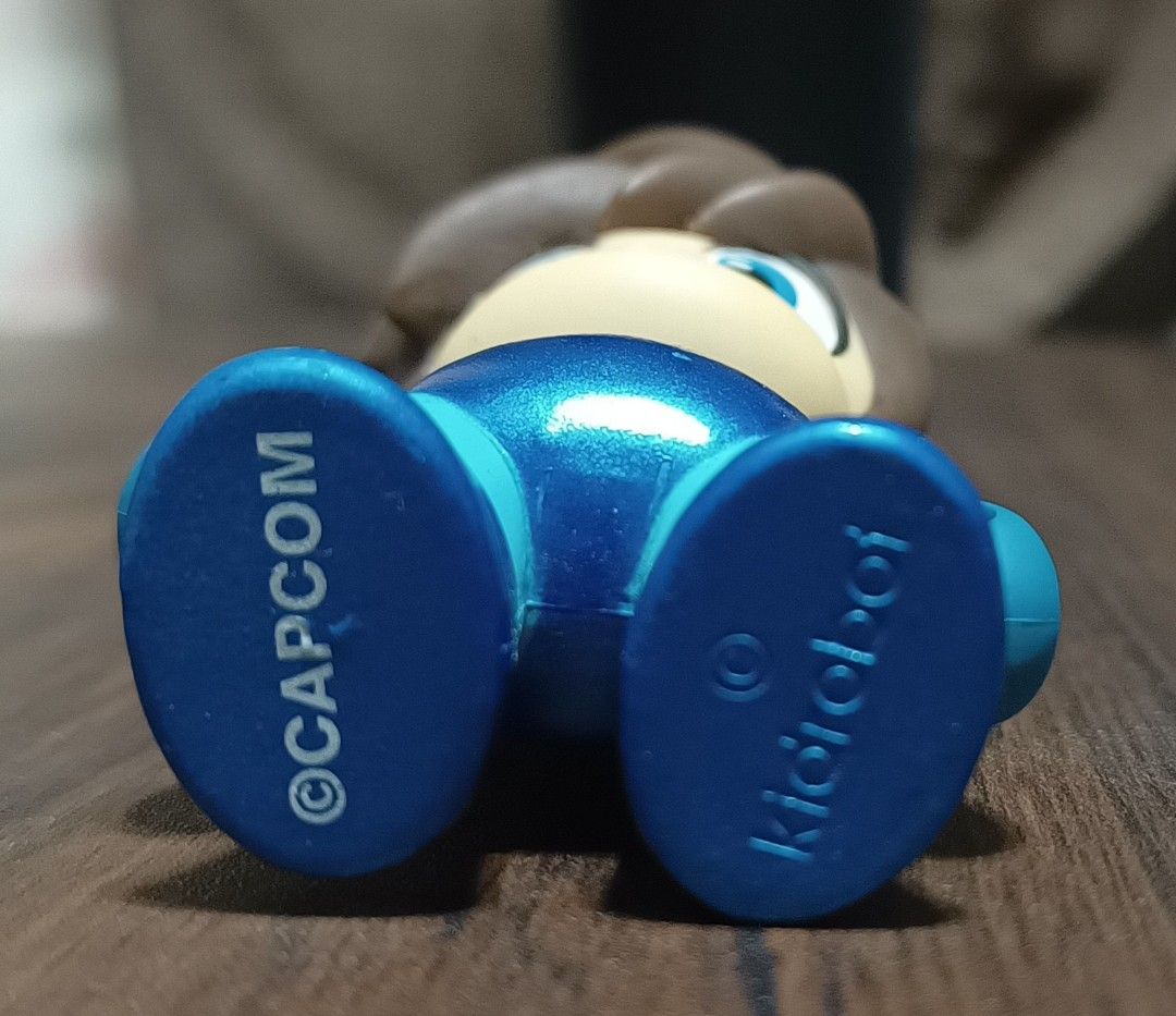 Kidrobot Mega Man "No Helmet" Chase vinyl figure (Category: Toys & Games) located in Calamba. Submitted by soulbricktoysshop (Listing ID 1440193697, Image 2). Description: This is a rare Kidrobot Mega Man "No Helmet" Chase vinyl figure from 2016. • Rarity: This specific figure is a "secret chase" variant, making it harder to find than standard figures in the series. •Design: It features Mega Man with his iconic hair exposed instead of wearing his
