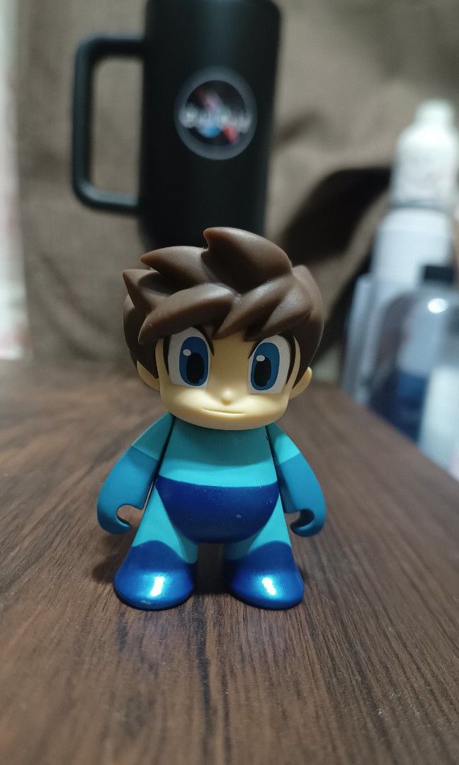 Kidrobot Mega Man "No Helmet" Chase vinyl figure (Category: Toys & Games) located in Calamba. Submitted by soulbricktoysshop (Listing ID 1440193697, Image 1). Description: This is a rare Kidrobot Mega Man "No Helmet" Chase vinyl figure from 2016. • Rarity: This specific figure is a "secret chase" variant, making it harder to find than standard figures in the series. •Design: It features Mega Man with his iconic hair exposed instead of wearing his