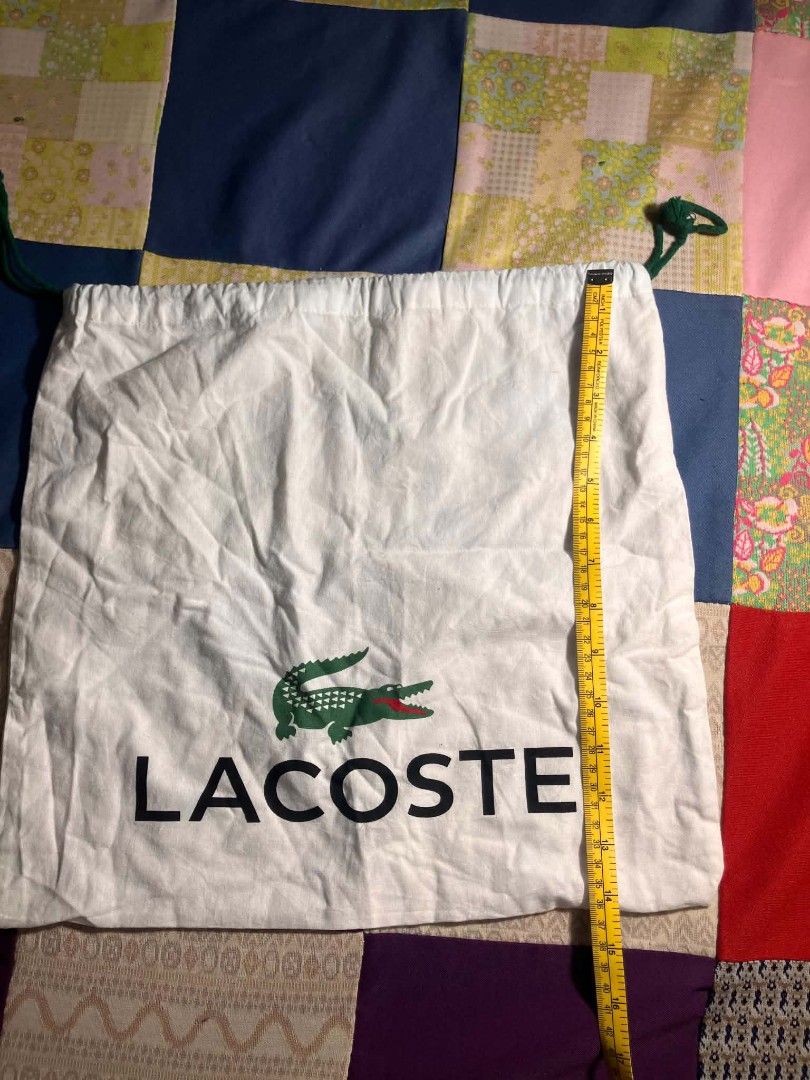 Lacoste Dust Bag (Category: Shoulder Bags) located in Manila. Submitted by ninjadisplay (Listing ID 1440091374, Image 2). Description: ​Brand: Lacoste ​Type: Dual-Cinch Drawstring Protection Dust Bag ​Colorway: Off-White with Signature Green & Black Logo Accents ​Drawstring Color: Forest Green ​📐 Flat Dimensions: ​Width: ~15.5 inches / 39.5 cm ​Height: ~15.5 inches / 39.5 cm.
