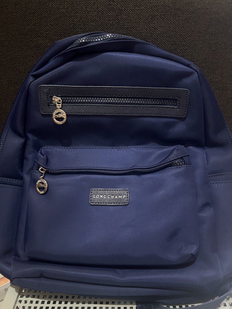 Longchamp Backpack Nylon (Category: Backpacks) located in Bacoor. Submitted by faith.hope.love28 (Listing ID 1440044096, Image 1). Description: - Stylish and practical Longchamp nylon backpack - Multiple zippered compartments for organized storage - Available in a variety of colors - Perfect for everyday use, travel, or school.