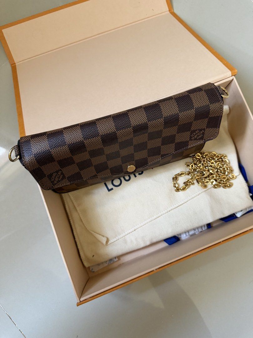 LV Damier Ebene Canvas Envelope Wallet on chain (Category: Luxury Bags & Wallets) located in Baguio. Submitted by 89threads (Listing ID 1440027626, Image 3). Description: - Authentic Louis Vuitton Damier Ebene wallet on chain - Iconic checkered pattern with red interior - Detachable gold-tone chain strap for versatile wear - Includes original Louis Vuitton box and dust bag - Perfect for organizing essentials.