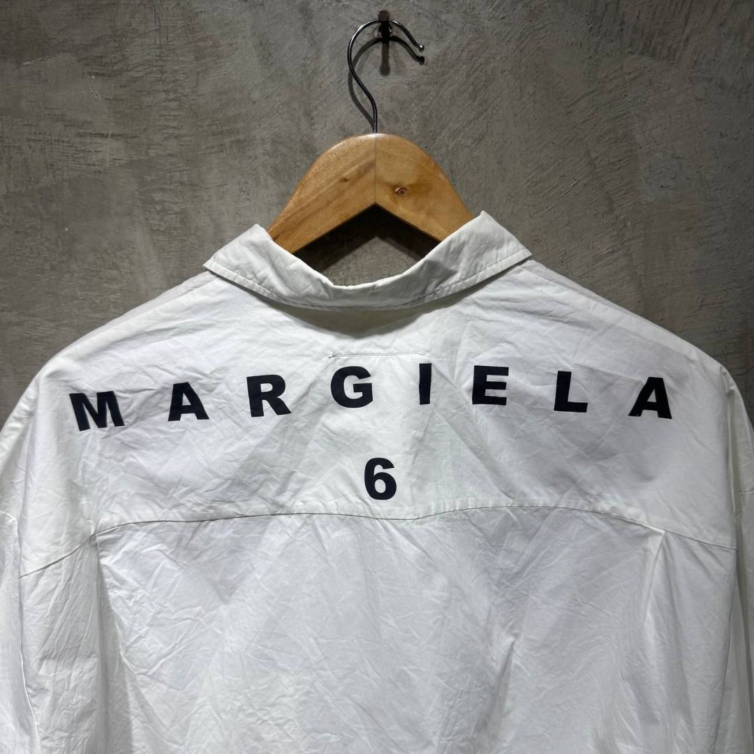 Maison Margiela Spell out MM6 Cropped Button down shirt (Category: Luxury Apparel) located in Quezon City. Submitted by johnpaulperezzz (Listing ID 1440070867, Image 2). Description: NAME: Maison Margiela Spell out MM6 Cropped Button down shirt COLOR: White SIZE: 42 FIT: Large Dimension: Width: 27 Length: 20 Shoulder: 23 Sleeves: 12 Hem: 28 CONDITION: 8.5/10 ISSUE: -crumpled, needs to be brought to a professional cleaner to have it ironed PRICE: 