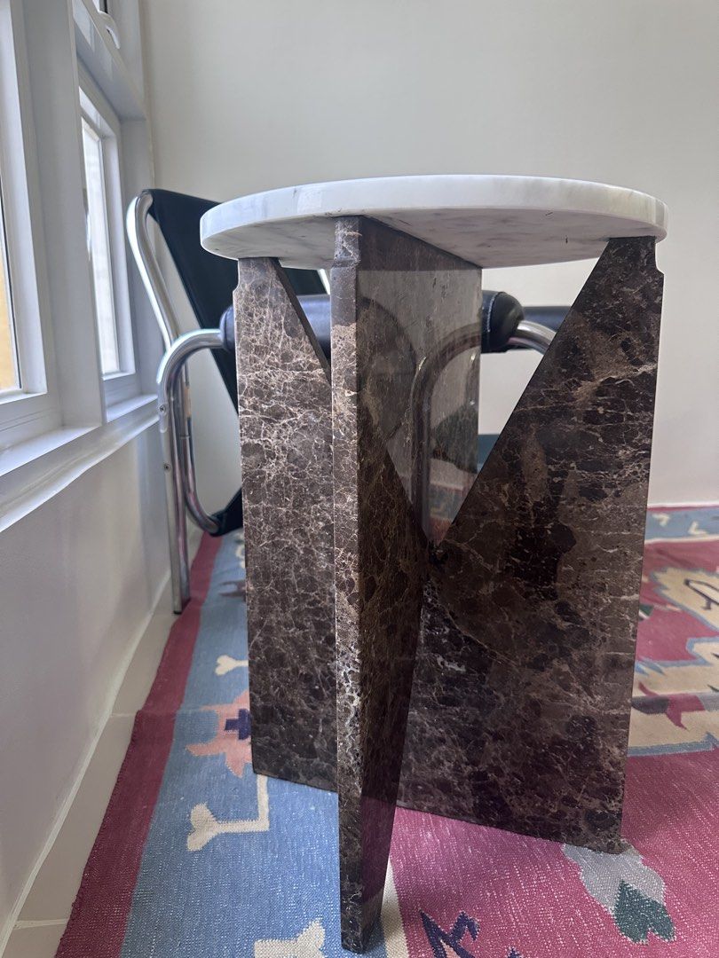 Marble Side Table with Unique Base (Category: Tables & Sets) located in Makati City. Submitted by tishmahtani (Listing ID 1440075164, Image 2). Description: - Elegant white Bianco Carrara marble top with beautiful veining - Modern dark, Emperador marble patterned geometric base - Striking contrast for a stylish look - Ideal accent piece for living rooms or bedrooms - Perfect for drinks, decor, or as a bedside table - Around 15kg Bought for Php 22