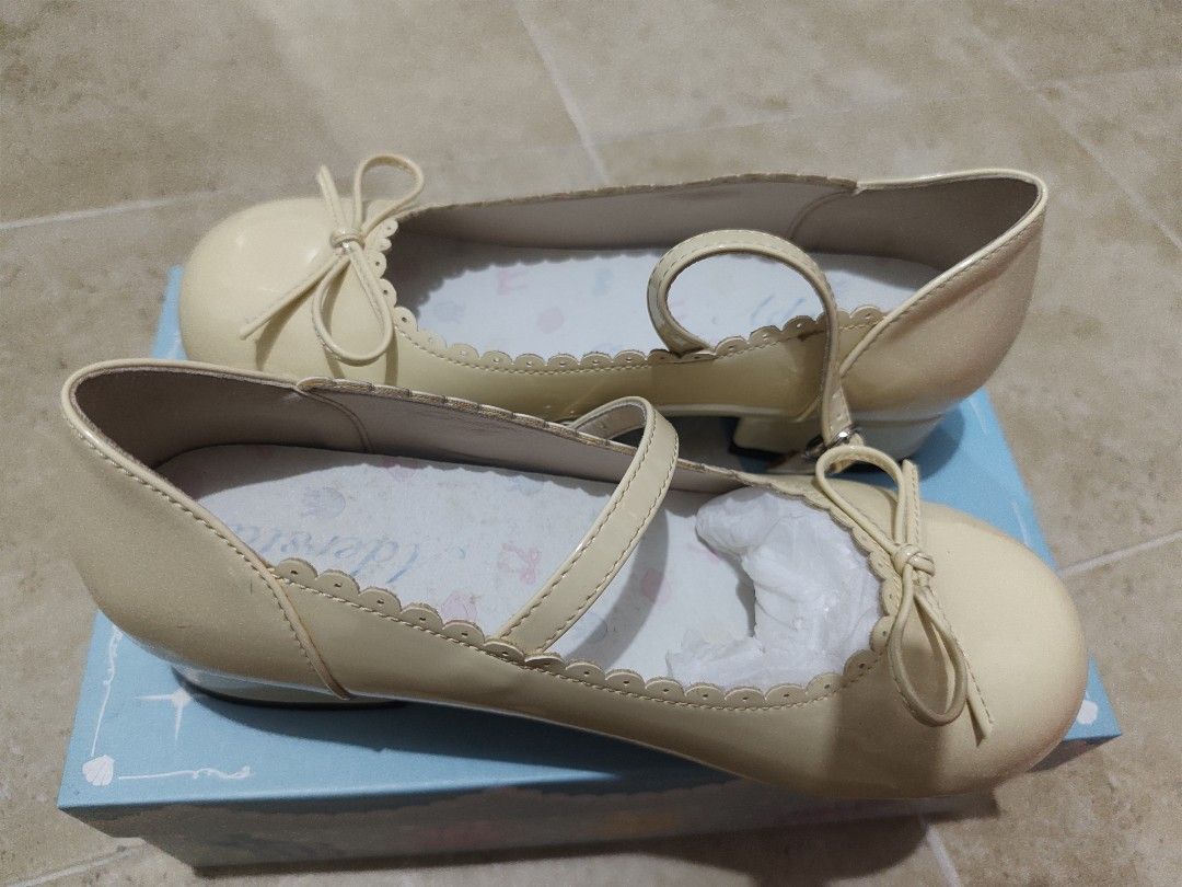 Mary Jane Shoes with Bow and Strap (Category: Flats & Sandals) located in Manila. Submitted by jecacruz2892 (Listing ID 1440191388, Image 1). Description: - Chic cream patent Mary Jane shoes - Delicate bow accent on the toe - Secure ankle strap - Sweet scalloped edge detail - Perfect for a polished look - Includes original box.