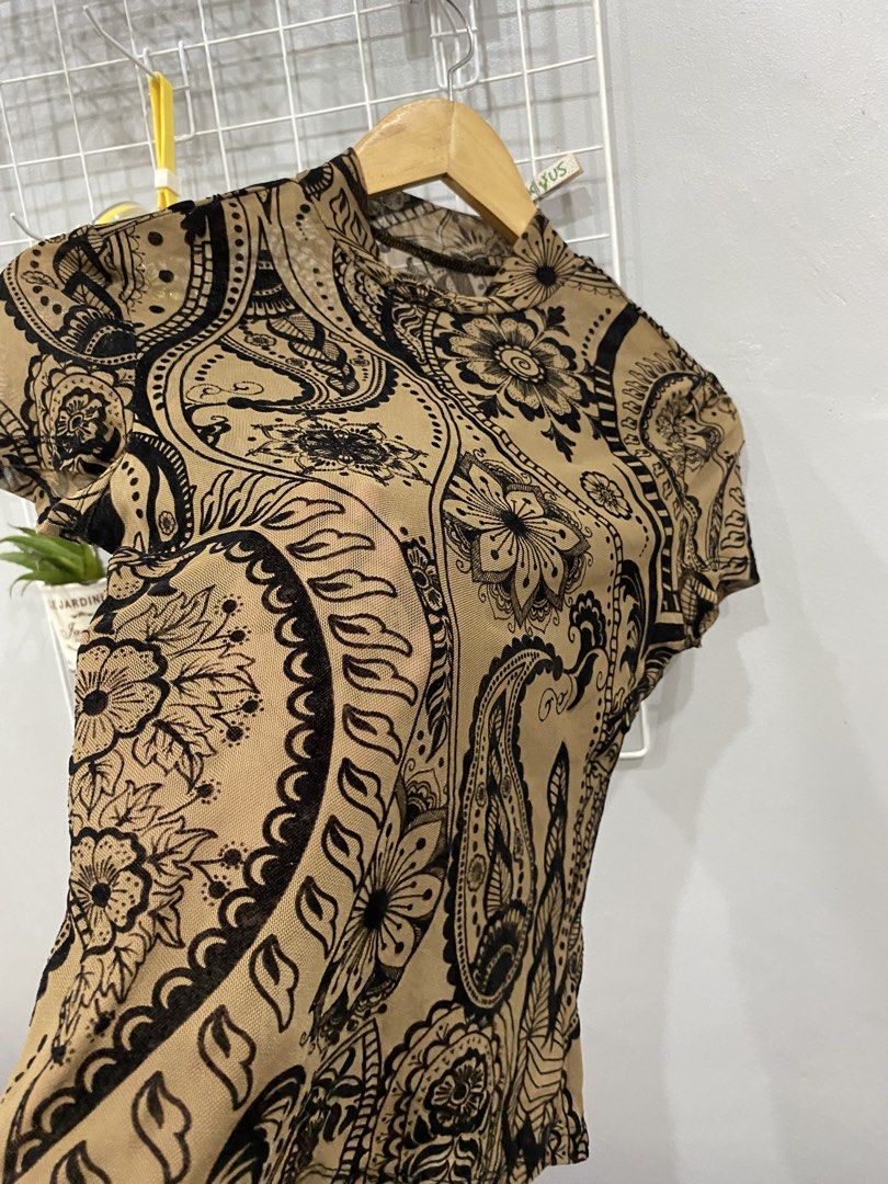 Mesh Mock Neck Top with Paisley Print (Category: Blouses) located in Kalibo. Submitted by bonsaiclo (Listing ID 1440063509, Image 3). Description: - Stylish sheer mesh top - Mock neck and short sleeves - All-over black paisley and floral print on tan background - Perfect for creating a trendy layered look.