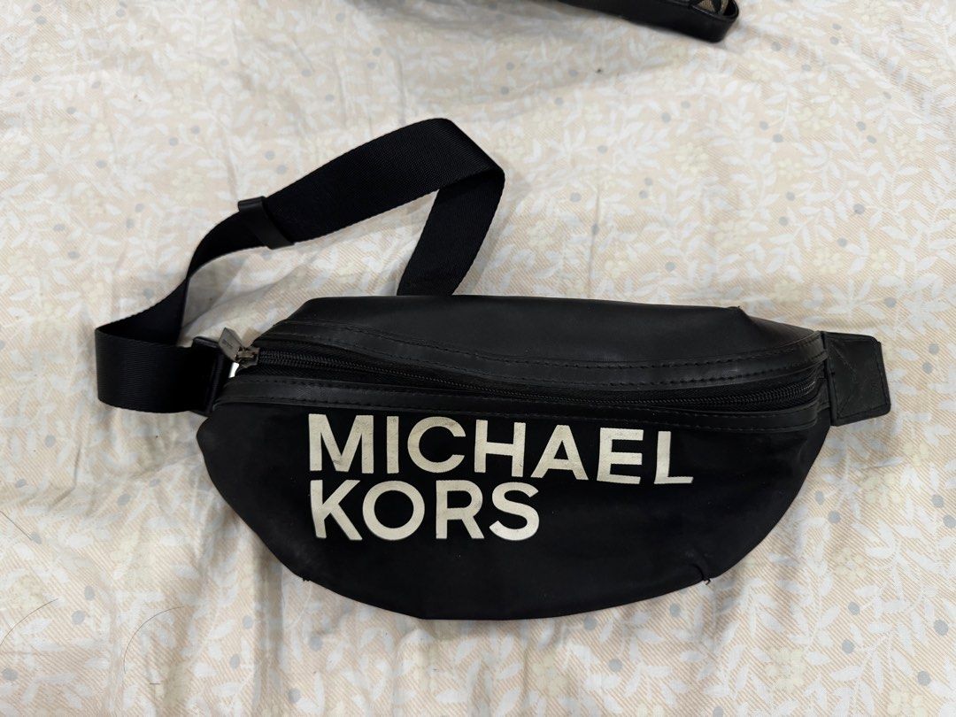 Michael Kors Black Nylon Waist Bag (Category: Luxury Bags & Wallets) located in Dasmarinas. Submitted by cheskarciaga (Listing ID 1440034757, Image 1). Description: - Authentic Michael Kors waist bag in classic black. - Features the signature Michael Kors logo prominently on the front. - Secure zippered main compartment for your essentials. - Adjustable strap for a comfortable, customized fit. - Ideal for hands-free convenience and everyday use..