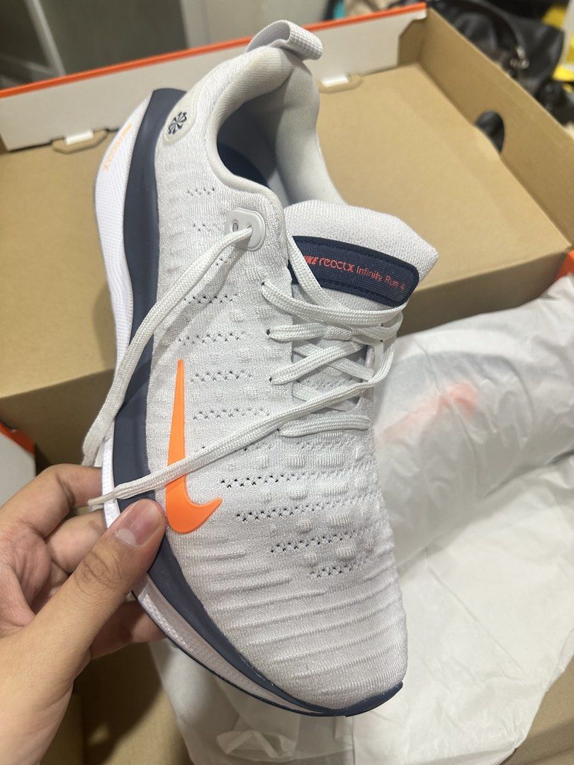 Nike Reactx Infinity Run 4 Platinum Tint/Total Orange Men's Shoes (Category: Sneakers) located in Bulacan. Submitted by dorothy.cruz (Listing ID 1440093312, Image 2). Description: NEVER BEEN USED - Nike Reactx Infinity Run 4 - Color: Platinum Tint with Total Orange accents - Breathable knit upper - Durable rubber outsole for excellent traction - Designed for a responsive and supportive running experience.