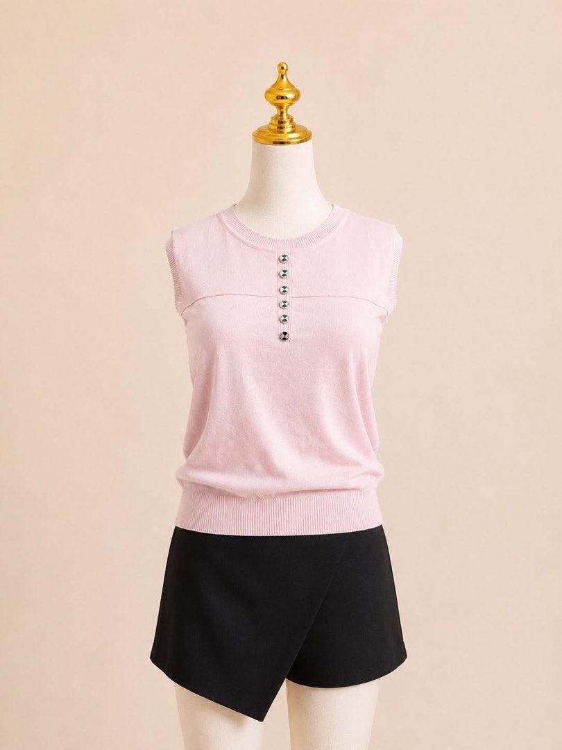 Pink Sleeveless Button-Up Top (Category: Sleeveless) located in Taguig. Submitted by s.showi (Listing ID 1440044377, Image 1). Description: - Soft pink sleeveless top - Subtle ribbed texture - Silver button detail at neckline - Stylish black skort (skirt look, shorts practicality) - Perfect for a casual yet put-together outfit.