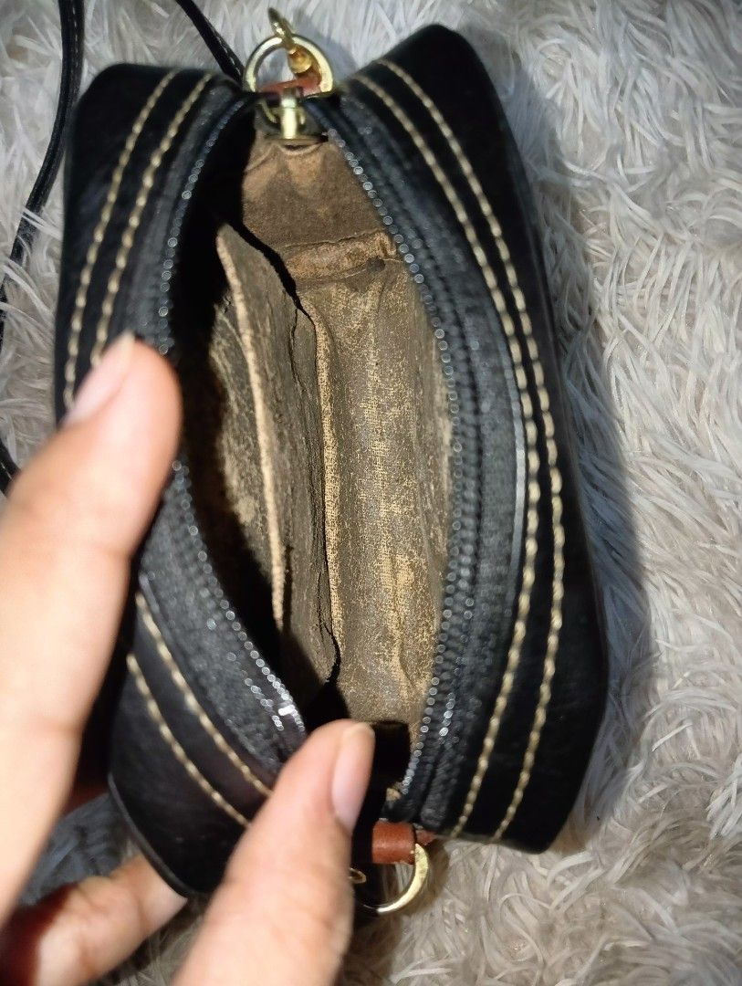 Pond's Black Leather Pouch Bag with Strap (Category: Purses & Pouches) located in Rizal. Submitted by zavrias_closet. (Listing ID 1440078252, Image 3). Description: - Stylish black leather pouch bag from Pony's. - Brown leather accent strap with embossed Pony's logo. - Small brown leather patch with a horse emblem. - Detachable braided strap for shoulder or crossbody wear. - Interior has a small compartment. - Perfect for carrying your essentials