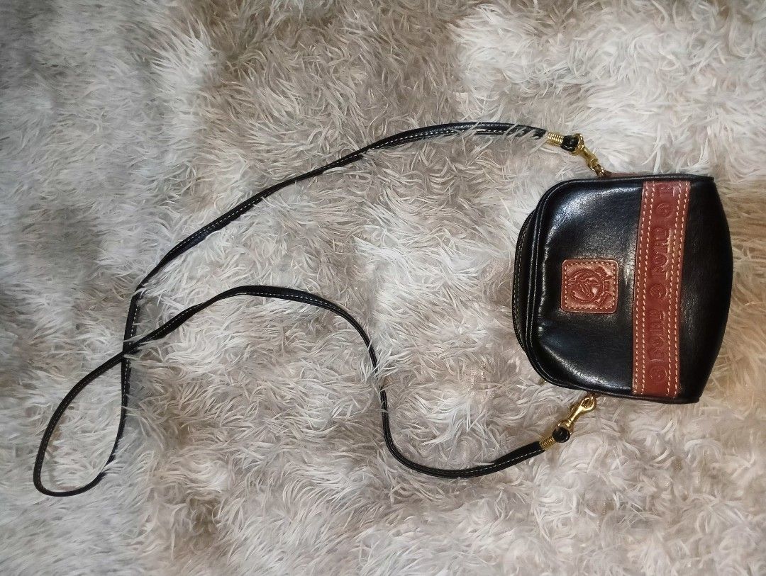 Pond's Black Leather Pouch Bag with Strap (Category: Purses & Pouches) located in Rizal. Submitted by zavrias_closet. (Listing ID 1440078252, Image 2). Description: - Stylish black leather pouch bag from Pony's. - Brown leather accent strap with embossed Pony's logo. - Small brown leather patch with a horse emblem. - Detachable braided strap for shoulder or crossbody wear. - Interior has a small compartment. - Perfect for carrying your essentials