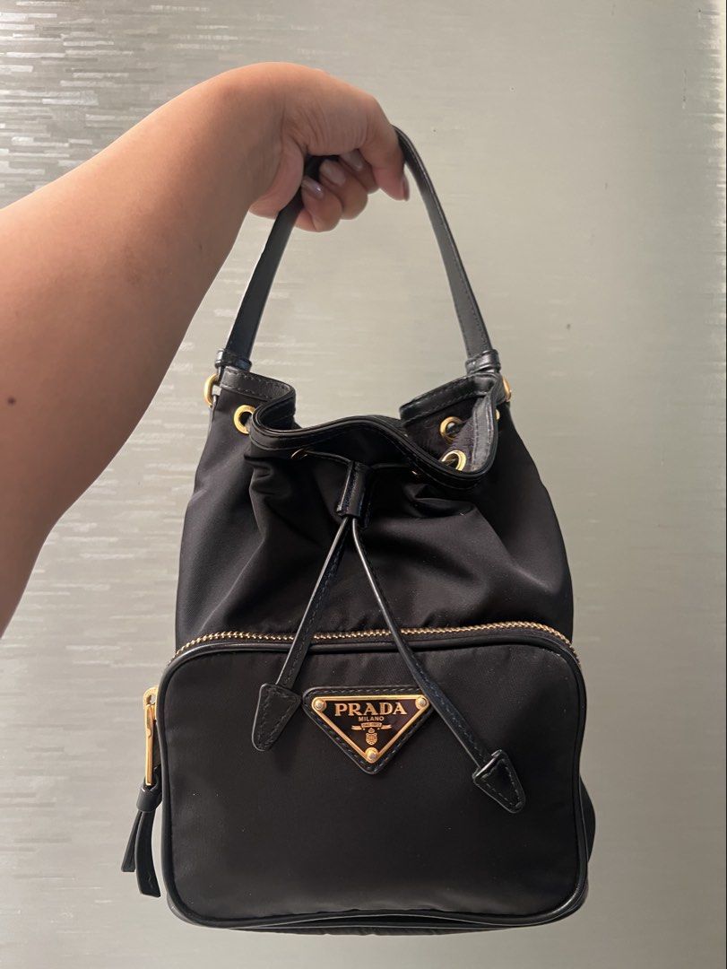 Prada Duet Re-Nylon Bucket Bag - Authentic (Category: Luxury Bags & Wallets) located in Manila. Submitted by niftyshopperph (Listing ID 1434229456, Image 1). Description: REPRICED FROM 55k DOWN TO 48K Bag ni Kathryn Bernardo! 🥰 No issues, in excellent condition! Gold na gold pa yung hardware, no fading. The perfect casual daily bag. Super lightweight and durable. Message me for detailed photos ❤️ Negotiable pa, direct pm na lang. Don’t be shy, I