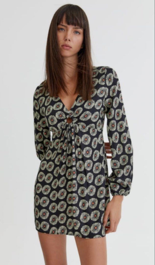 Pull & Bear Black Floral Print Cut-Out Mini Dress (Category: Dresses) located in Cagayan de Oro. Submitted by jeirn (Listing ID 1440007546, Image 1). Description: Retails at 2,200 - Brand: Pull & Bear - Style: Mini Dress - Color: Black with vibrant all-over floral print - Neckline: V-neck with unique cut-out detail - Closure: Tie front - Sleeves: Long sleeves - Occasion: Perfect for day or evening events.