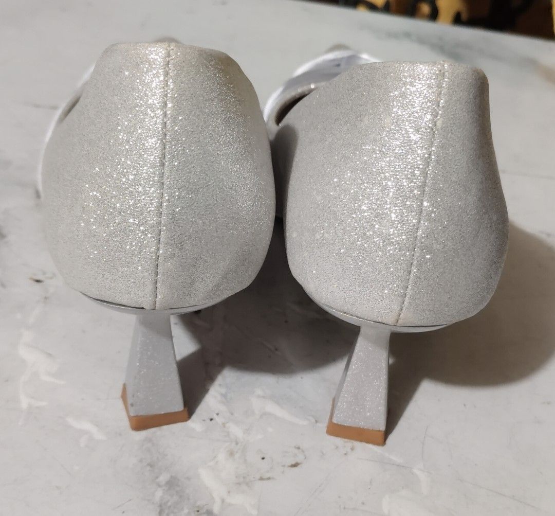 Rock & Rose Silver Glitter Heels with Satin Bow (Category: Heels) located in Quezon City. Submitted by liza.t (Listing ID 1440087979, Image 3). Description: - Brand: Rock & Rose - Color: Silver Glitter - Toe Style: Pointed - Detail: Chic satin bow at the front - Heel Type: Unique block heel - Occasion: Perfect for special occasions or adding sparkle to any outfit -used once.