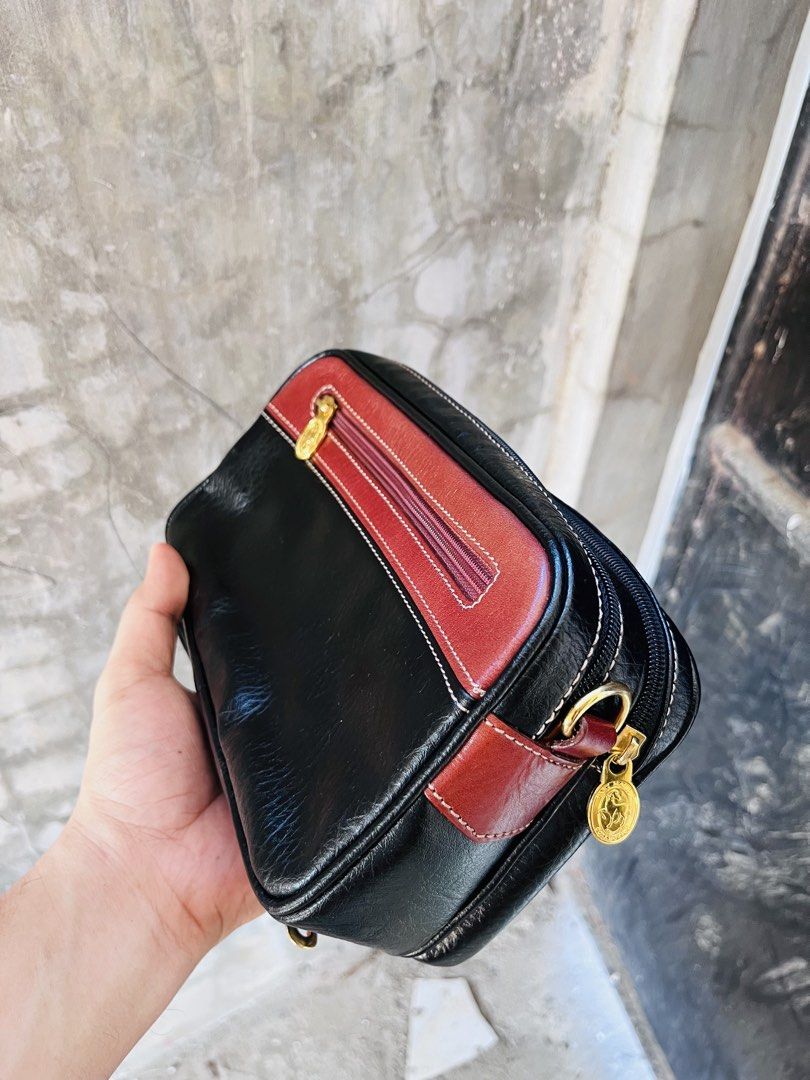 Sant Marios Collection Leather Clutch Bag (Category: Clutches) located in Ballesteros. Submitted by sat_b3 (Listing ID 1440008241, Image 3). Description: - Chic black and red leather clutch bag - From Sant Marios Collection - Zippered main compartment - Additional front zippered pocket - Detachable wrist strap for convenience - Perfect for organizing essentials - good condition(like new) - pwede nyo sya lagyan ng strap kung gusto nyo kc dalawa an